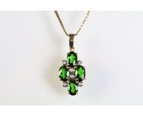 9ct gold pendant necklace being set with four oval cut chrome diopside gemstones with six bezel set diamonds accent stones. P