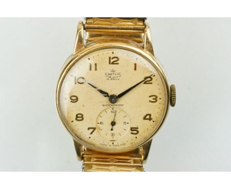 Smiths De Luxe 9ct gold cased gentlemen's wrist watch having a round face with arabic numerals to the chapter ring, subsidiar