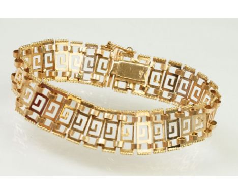 14ct gold greek key panel bracelet with pierced details to each link, with box clasp. Marked 585 to clasp. Measures 7 inches.