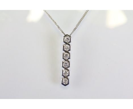 18ct white gold and diamond pendant necklace having a line pendant with six round brilliant cut diamonds. Hallmarked London t