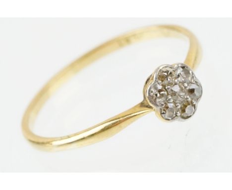 18ct gold and platinum diamond cluster daisy ring. The ring being set with seven single cut diamonds. Band marked 18ct &amp; 