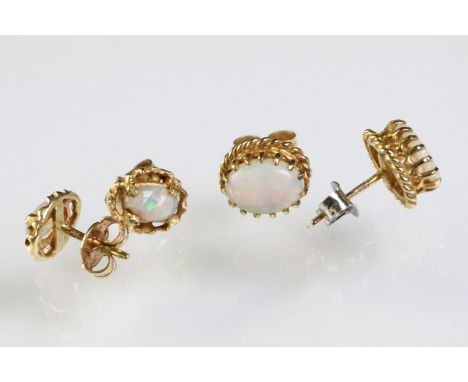 Two pairs of opal set stud earrings. The lot to include pair of 9ct opal cabochon earrings within a rope twist mount (hallmar