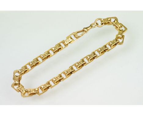 20th Century yellow metal fancy link bracelet chain having engraved oval links with swivel clasp. Foreign marks to jump ring,