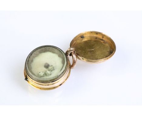 19th Century Victorian gaming dice spinner pendant being gold cased and housing three miniature dice within a glass topped ca