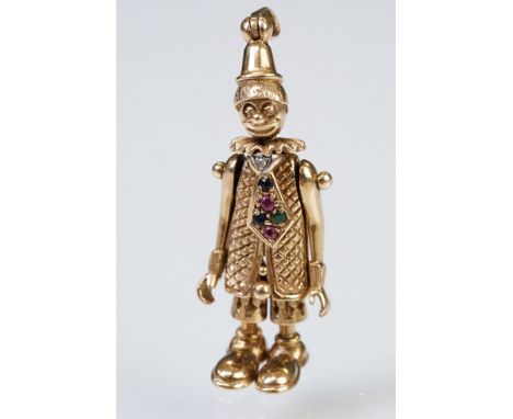 9ct gold hallmarked clown pendant having articulated limbs set with coloured stones to the tie. Import marked 1992. Measures 