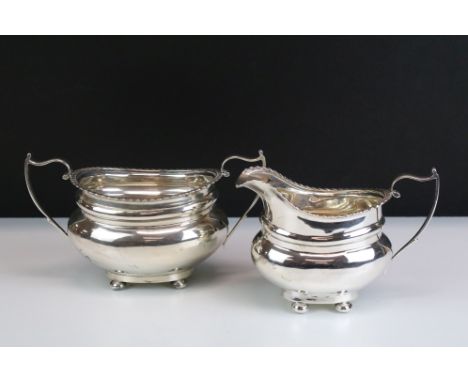 Early 20th century silver twin-handled sugar basin &amp; milk jug, of plain polished baluster form with shaped upper rim, the