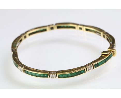 18ct gold emerald and diamond line bracelet. The bracelet having square step cut emerald panels set alternately with round br