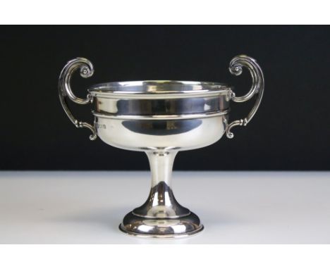 1920s William Hutton &amp; Sons silver hallmarked trophy cup having twin scrolled handles raised on a pedestal base. Hallmark