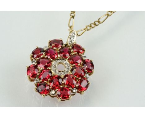 9ct gold ruby and diamond cluster pendant being set with sixteen oval cut rubies around a centre of diamond accent stones. Ha