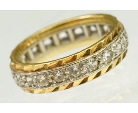 Two tone 18ct gold and white stone eternity ring. Marked 18ct to band. Size G.5. 