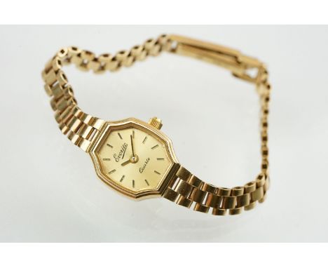 Ladies Everite 9ctr gold wrist watch having a canted rectangular dial with baton markers to the chapter ring set to a 9ct gol