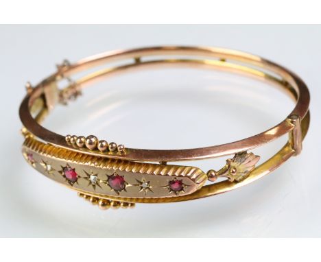 19th Century Victorian 9ct gold, ruby and diamond hinged bangle bracelet. The bracelet consteucted from two knife bars with b