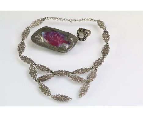 Early 20th Century Art Nouveau Ruskin style brooch having a purple and blue glazed panel to the centre set within a floral pe