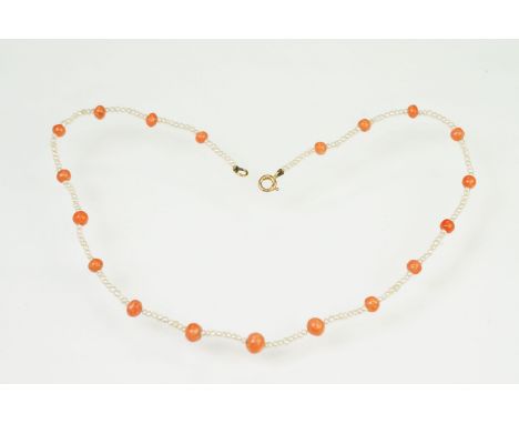 Coral and seed pearl beaded necklace being strung with round coral beads with small seed pearls and a 9ct gold spring ring cl