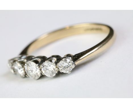 18ct gold and diamond five stone ring being set with five graduating round brilliant cut diamonds. Band marked 18ct &amp; Pla