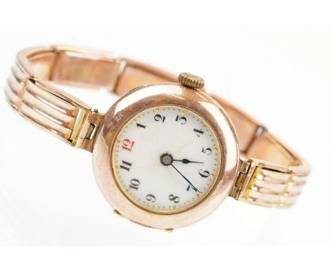 Early 20th Century 9ct gold hallmarked wrist watch. The watch having a round white enamelled face with arabic numerals to the