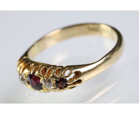 9ct gold garnet and diamond five stone ring. The ring being set with three round cut garnets with two alternately set round c