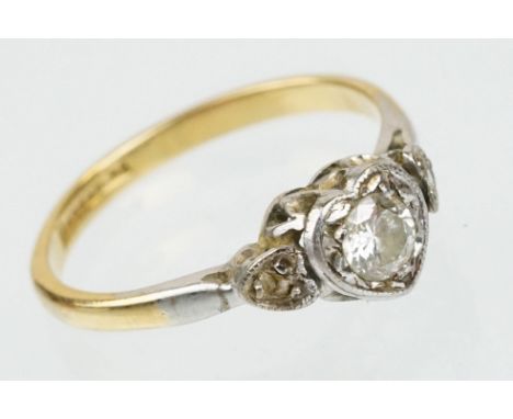 18ct gold diamond solitaire ring. The ring being set with a round brilliant cut diamond set within a platinum heart shaped se