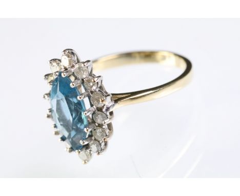 9ct gold, topaz and diamond cluster ring. The ring being set with a marquise cut blue topaz with a halo of round cut diamonds