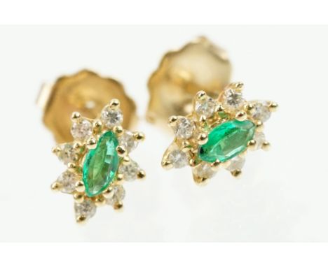 Pair of 14ct gold, emerald and diamond cluster earrings. The each set with a central marquise cut emerald with a halo of roun