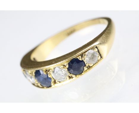 18ct gold sapphire and diamond seven stone ring set with three round cut sapphires and four round cut diamonds. marked 18ct t