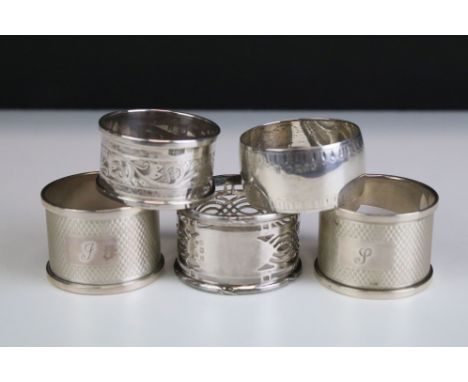 Five silver hallmarked napkin rings to include a pair of engine turned examples (hallmarked Birmingham 1956), a pierced examp