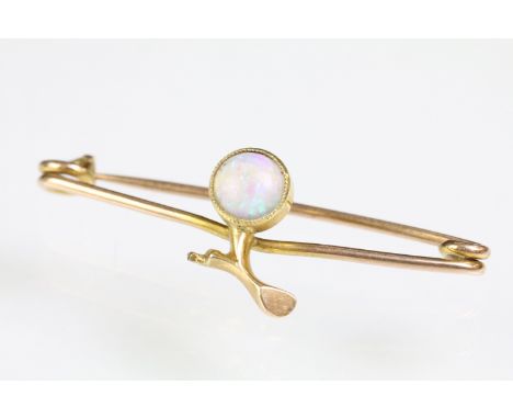 Antique opal and gold safety pin brooch having a round opal cabochon set to the centre. Unmarked, assessed as 9ct gold. Measu
