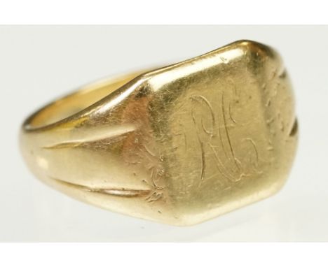 9ct gold signet ring having a square head with reeded shoulders. Marked 9ct to shank. Head engraved with initials. Size R. 