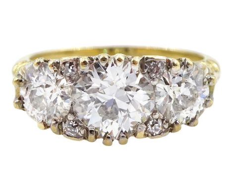 18ct gold three stone diamond ring, the central diamond of approx 1.15 carat, with four diamond accents set between, total di