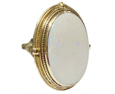 Large gold oval opal ring, with textured mount