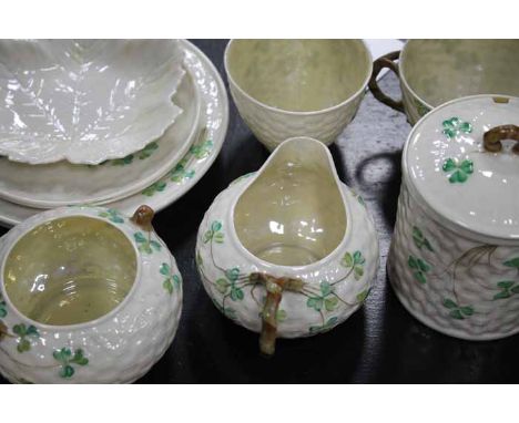 20TH CENTURY BELLEEK CLOVER LUSTRE PORCELAIN PART TEA SERVICE
comprising two cups, preserve pot, sugar bowl, cream jug, two s