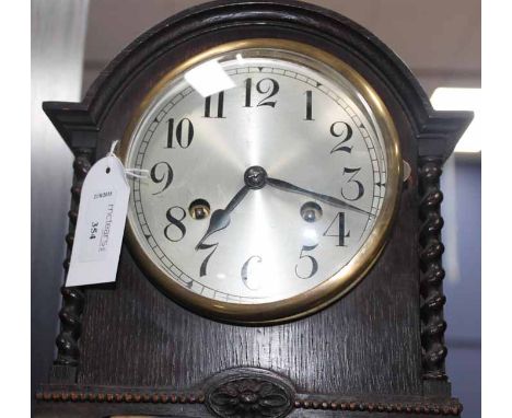 OAK MANTEL CLOCK
the silvered dial with Arabic numerals, front key wind, pendulum, chiming on a coil, 23cm high, 22cm wide, g