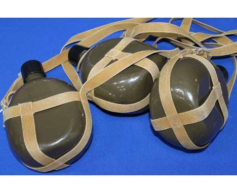 THREE MILTARY STYLE WATER CANISTERS
olive green enamel, canvas straps, each 21cm high