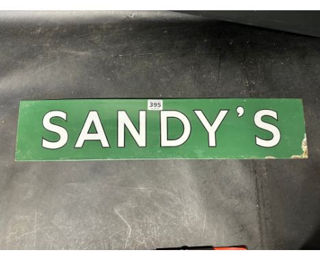 An enamel sign for 'Sandy's', 23 1/2 x 5". 