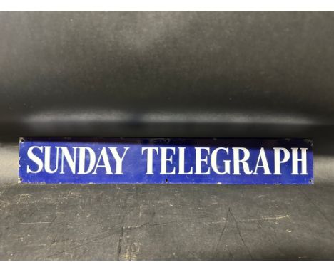 A Sunday Telegraph enamel advertising sign, 22 1/2 x 3 1/2". 