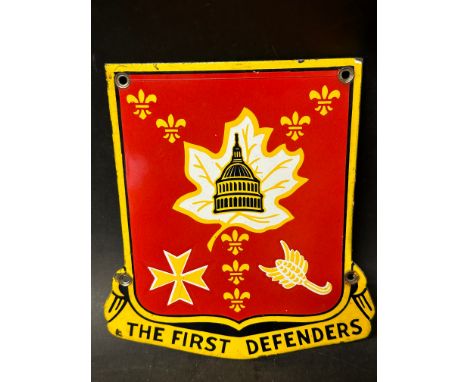 An enamel advertising sign for The First Defenders (U.S. version of the T.A.), 8 1/4 x 9".