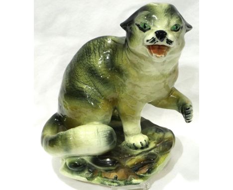 19th century glazed ceramic study of a Bobcat on a naturalistic base, H: 24 cm, light crazing throughout, no visible damages.