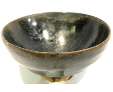 A Song dynasty (likely southern region) black glazed bowl, footed, D: 10 cm, H: 4 cm. P&amp;P Group 1 (£14+VAT for the first 