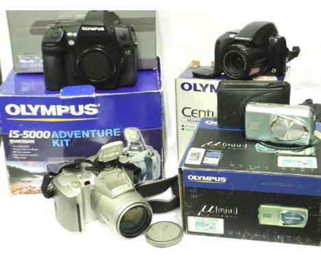 Four boxed Olympus cameras including an Olympus is-5000 Adventure Kit. P&amp;P Group 2 (£18+VAT for the first lot and £3+VAT 