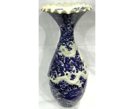 Large blue and white Oriental vase with dragon relief decoration and fluted neck, H: 54 cm, no cracks or chips. P&amp;P Group