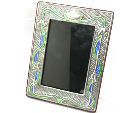 A pair of enamelled sterling silver easel frames, relief decorated in the Art Nouveau manner, each 15 x 19 cm, interior dimen
