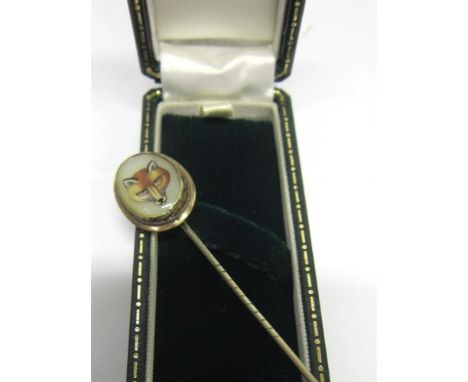 A VICTORIAN 9CT GOLD STICK PIN With oval fox mask, white enamel reverse painted & with opal back