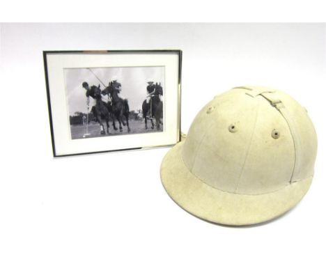 A WHITE POLO HELMET  Size 6 7/8', together with a photo of the late owner in a polo match with Prince Charles