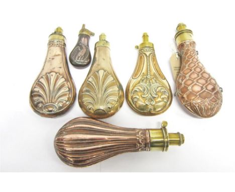 FIVE COPPER POWDER FLASKS brass mounted and with stylised decoration and a miniature powder flask with eagle decoration (6)