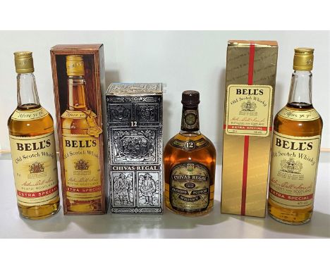 Two boxed bottles of vintage Bells Old Scotch Whiskey, extra special one gilt box and a bottle of 12 years Chivas Regal. 