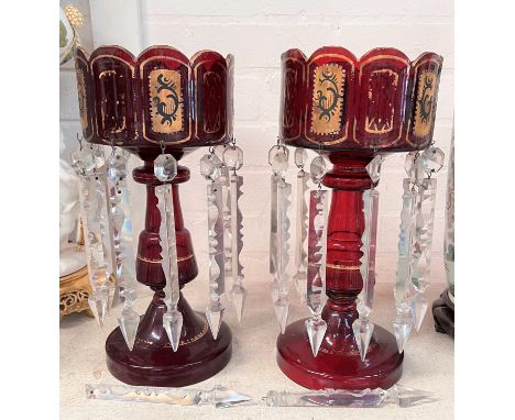 A Victorian pair of ruby glass lustres with gilded decoration and faceted drops 