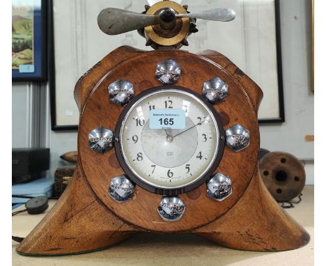 A wooden propeller clock with cut down sections, carved details with chromed bolts; a Smiths clock, a smaller propeller above