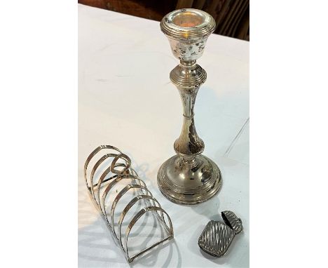 A hallmarked silver 6 division arched toast rack, Birmingham 1933, 2.75oz; a hallmarked silver candlestick with turned column