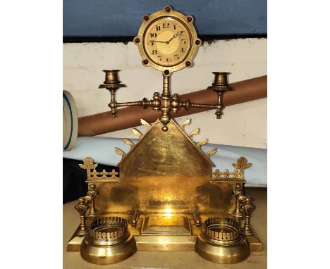 A 19th century Asthetic movement brass mantel clock with twin candelabra to each side, small hinged compartment the clock fac