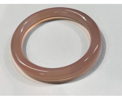 A Chinese rose jade coloured hoop bangle, diameter 8cm 